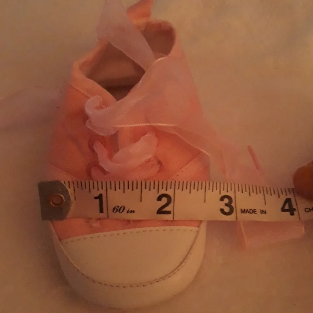 Pink baby sneakers with moon and star beaded accents and fun laces